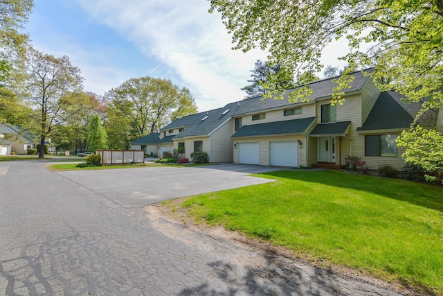52 Ridgewood Dr Unit 14C, Atkinson, NH 03811 - view of front facade featuring driveway, a shingled roof, a front yard, and an attached garage