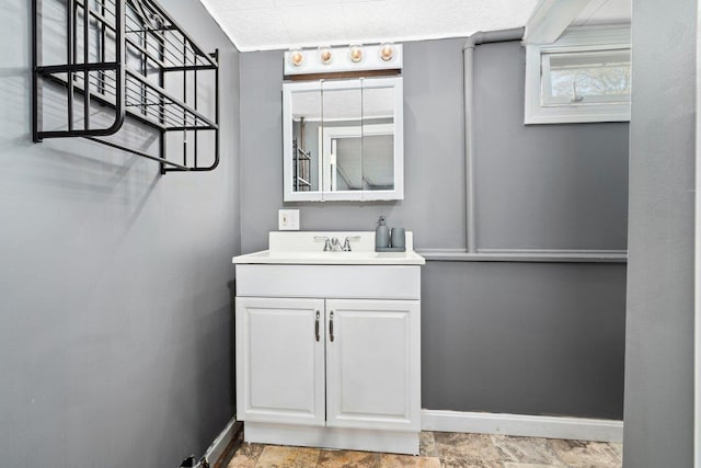 bathroom featuring baseboards and vanity