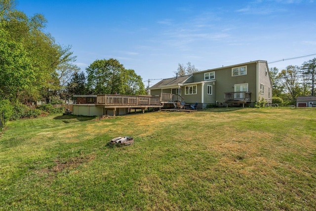 view of grassy yard with a wooden deck