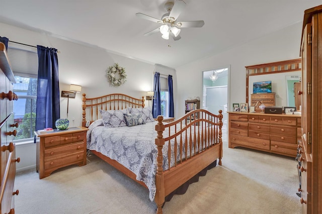bedroom featuring light carpet, lofted ceiling, and ceiling fan