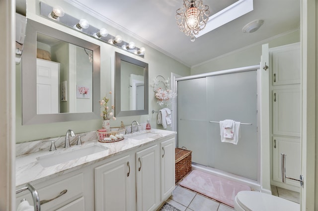 bathroom with ornamental molding, a shower stall, tile patterned floors, double vanity, and toilet
