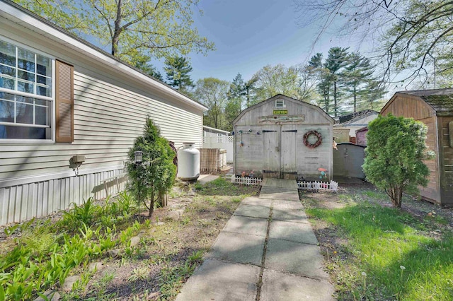 view of yard with a storage shed and an outbuilding