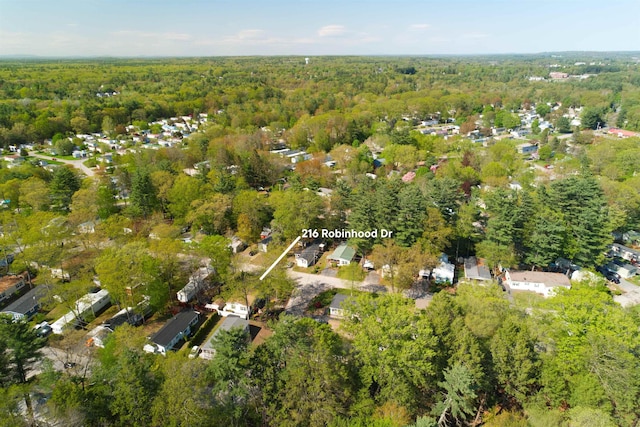 aerial view of property's location with a heavily wooded area