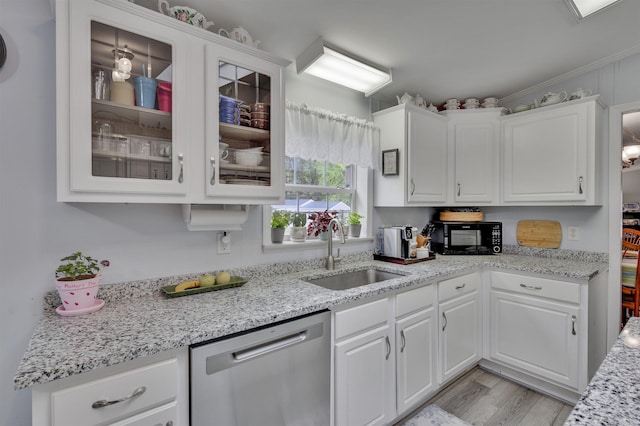 kitchen with dishwasher, a sink, black microwave, and white cabinetry
