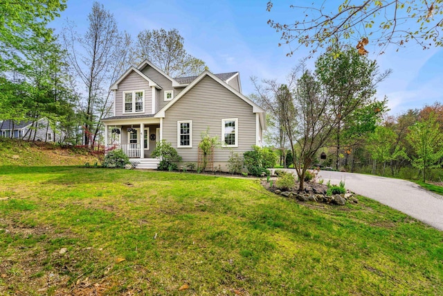 traditional-style home with a porch and a front lawn