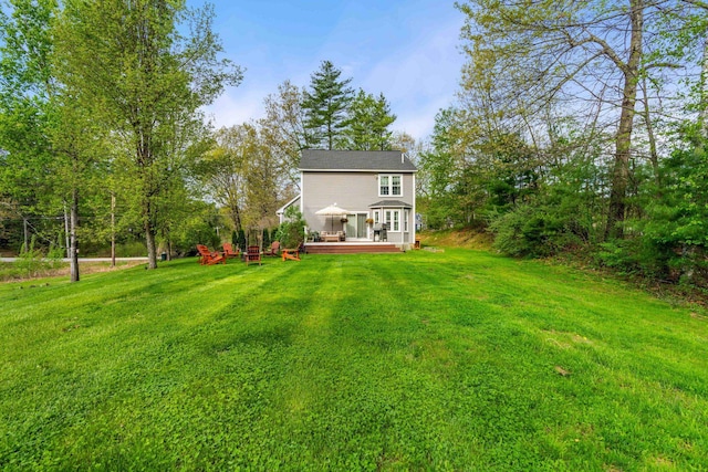 view of grassy yard featuring a wooden deck