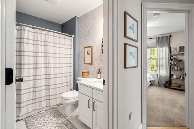 bathroom featuring vanity, toilet, and a shower with curtain