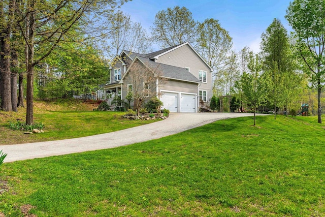 view of side of home with driveway, a yard, and a garage