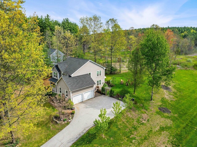 aerial view of property and surrounding area featuring a forest