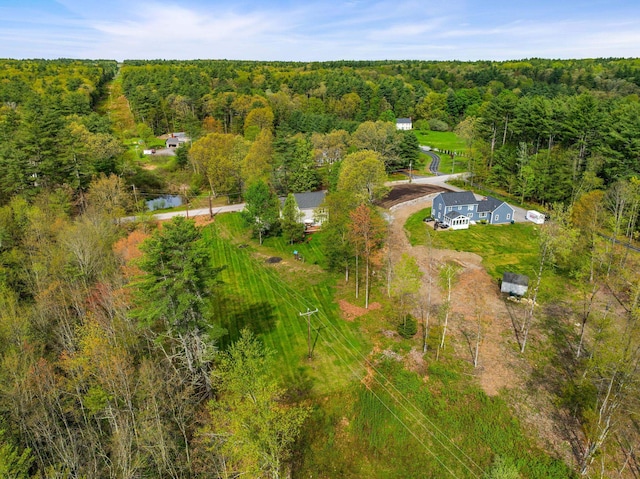 aerial view of property and surrounding area with a forest