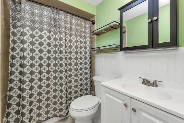 bathroom with toilet, vanity, and a shower with curtain