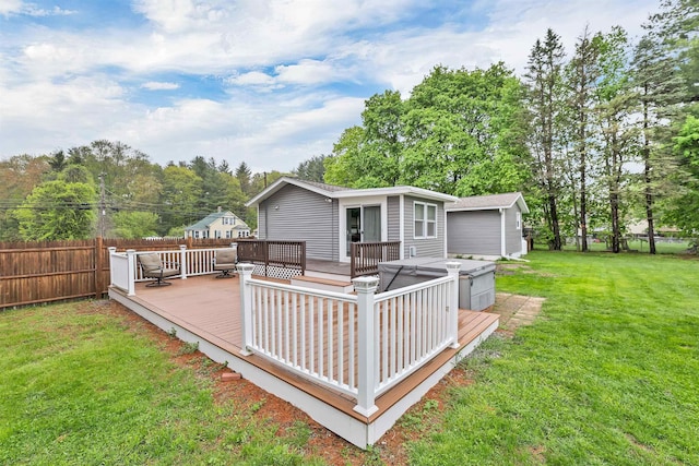 rear view of house with a hot tub, a deck, and view of wooded area