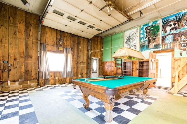 game room with tile patterned floors, wood walls, pool table, and a garage