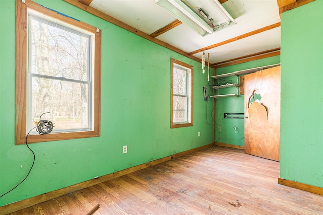 spare room featuring wood finished floors and baseboards