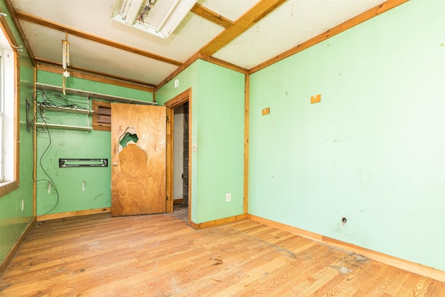 unfurnished room featuring wood finished floors and baseboards