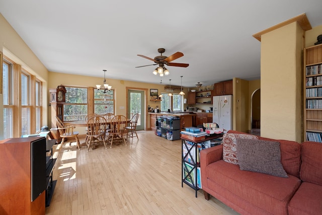 153 Wood Rd, Middlesex, VT 05682 - living area featuring arched walkways, light wood-style floors, a ceiling fan, and a chandelier