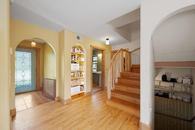 153 Wood Rd, Middlesex, VT 05682 - entryway with hardwood / wood-style floors, arched walkways, and stairs