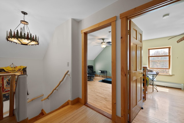 153 Wood Rd, Middlesex, VT 05682 - hallway featuring light wood-style floors, vaulted ceiling, baseboard heating, and baseboards