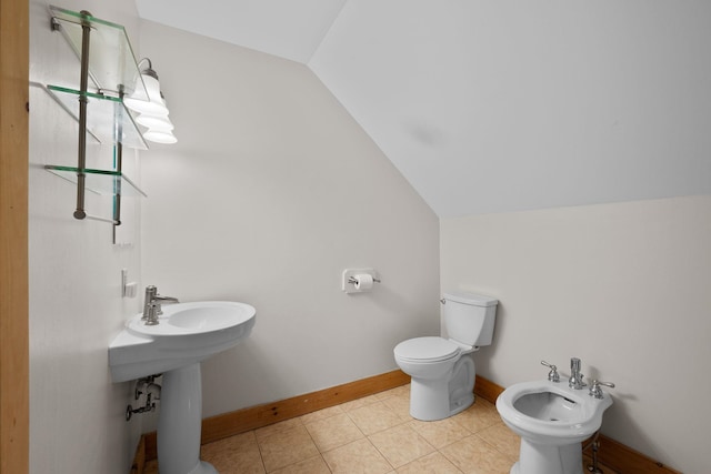 153 Wood Rd, Middlesex, VT 05682 - bathroom with vaulted ceiling, a bidet, baseboards, toilet, and tile patterned flooring
