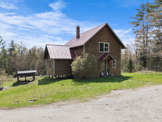 153 Wood Rd, Middlesex, VT 05682 - view of home's exterior featuring a standing seam roof, metal roof, a chimney, and a lawn