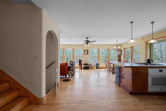 153 Wood Rd, Middlesex, VT 05682 - kitchen with oven, a ceiling fan, light wood-type flooring, hanging light fixtures, and a chandelier