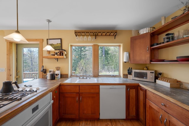 153 Wood Rd, Middlesex, VT 05682 - kitchen with white appliances, open shelves, a sink, brown cabinetry, and plenty of natural light