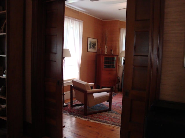 corridor featuring wood-type flooring and crown molding