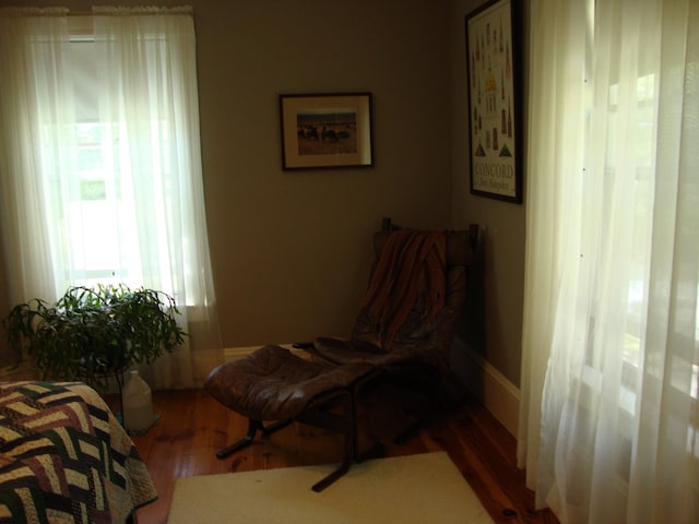 living area featuring wood finished floors and baseboards