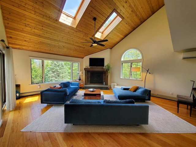 644 Methodist Hill Rd, Enfield, NH 03748 - living room with high vaulted ceiling, a stone fireplace, hardwood / wood-style flooring, baseboards, and a skylight