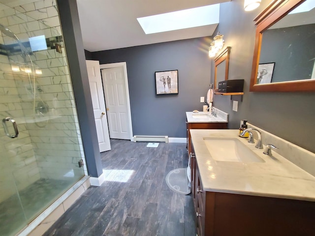644 Methodist Hill Rd, Enfield, NH 03748 - bathroom with a skylight, a baseboard radiator, wood finished floors, a shower stall, and baseboards