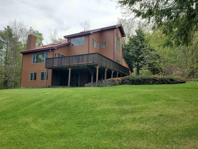 644 Methodist Hill Rd, Enfield, NH 03748 - back of property with a chimney, a lawn, and a deck