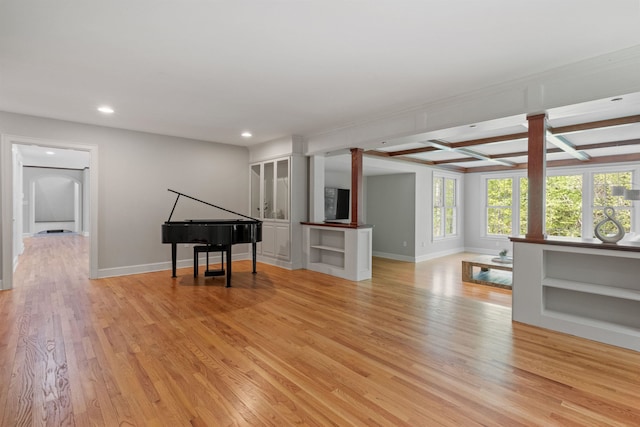 unfurnished living room featuring recessed lighting, light wood-style floors, baseboards, coffered ceiling, and beamed ceiling