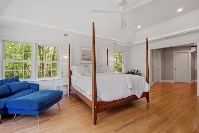bedroom with light wood finished floors, ceiling fan, recessed lighting, a wall unit AC, and baseboards