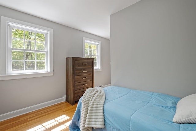 bedroom featuring light wood-type flooring and baseboards