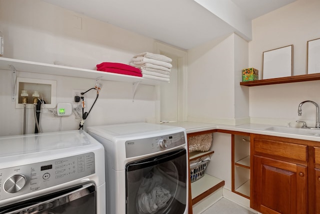 clothes washing area with washer and clothes dryer and cabinet space
