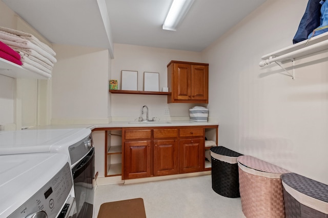 washroom featuring washer and clothes dryer and cabinet space