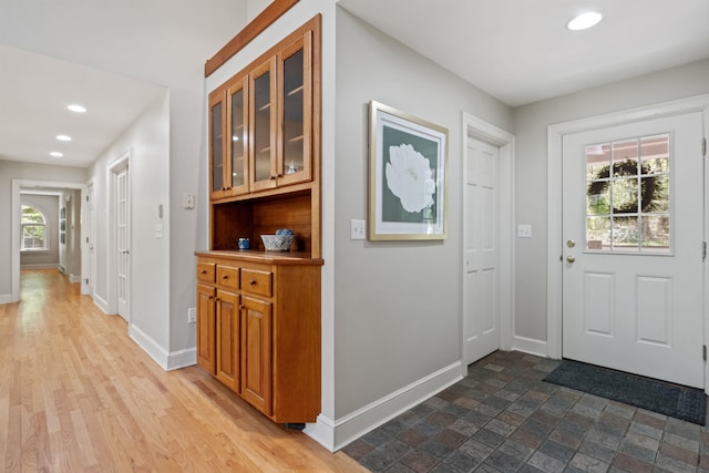 entrance foyer with baseboards and recessed lighting