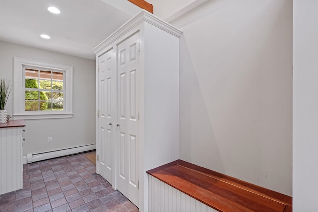 mudroom with baseboard heating, recessed lighting, and stone finish flooring