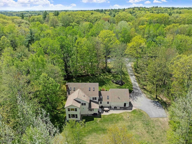 view of subject property featuring a heavily wooded area