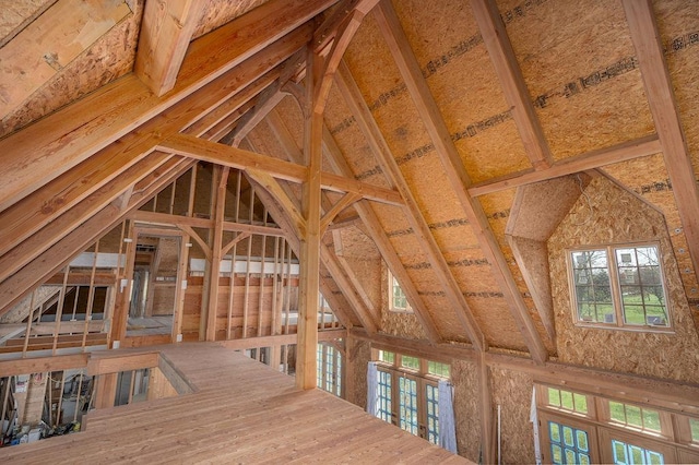 unfinished attic with an upstairs landing