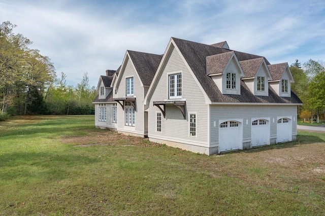 view of side of home with a chimney, a detached garage, a lawn, and a shingled roof