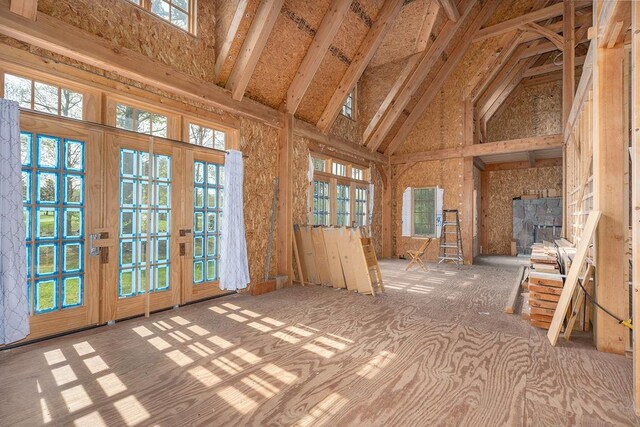 unfurnished sunroom with french doors, healthy amount of natural light, and lofted ceiling