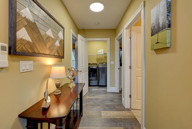 hall with independent washer and dryer, wood finished floors, and baseboards