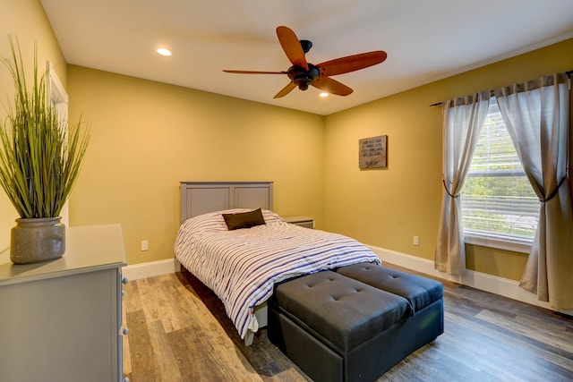 bedroom featuring wood finished floors, recessed lighting, baseboards, and a ceiling fan