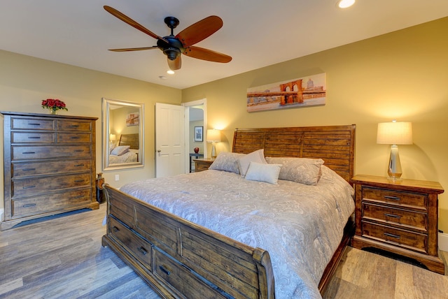 bedroom with wood finished floors, recessed lighting, and a ceiling fan