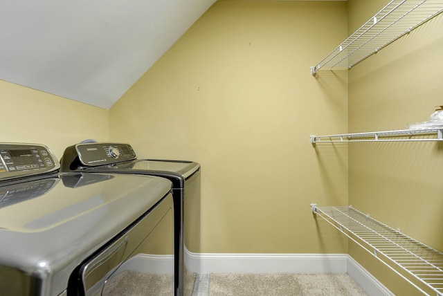 laundry room with washing machine and dryer, baseboards, and carpet floors