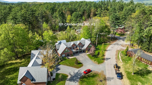 view of subject property with a heavily wooded area