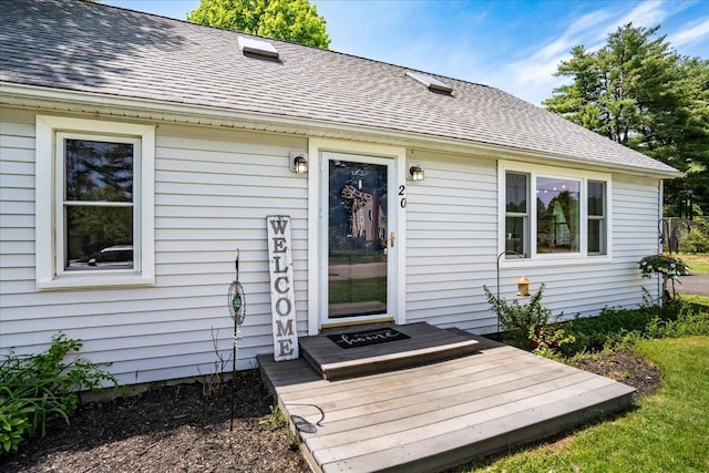 property entrance with roof with shingles