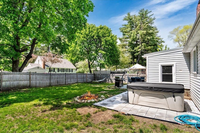 view of yard featuring a hot tub and a fire pit
