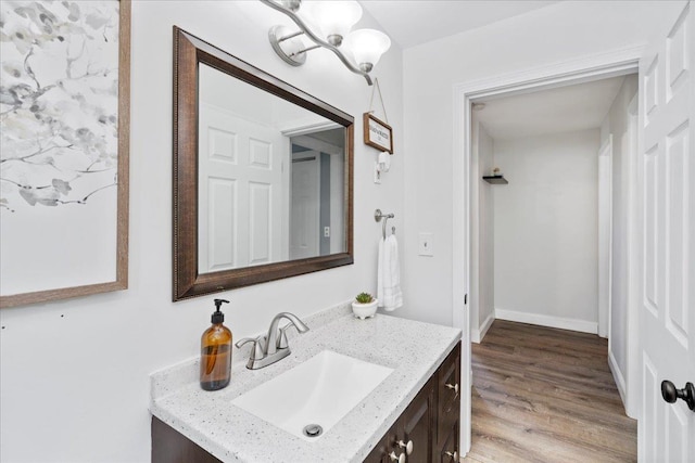 bathroom featuring a chandelier, vanity, and wood finished floors